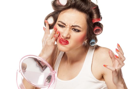 Women trying to remove makeup that won't budge.